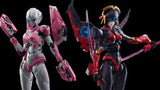 Two action figures, one pink and white, the other red and black, on a reflective black surface with a dark background.